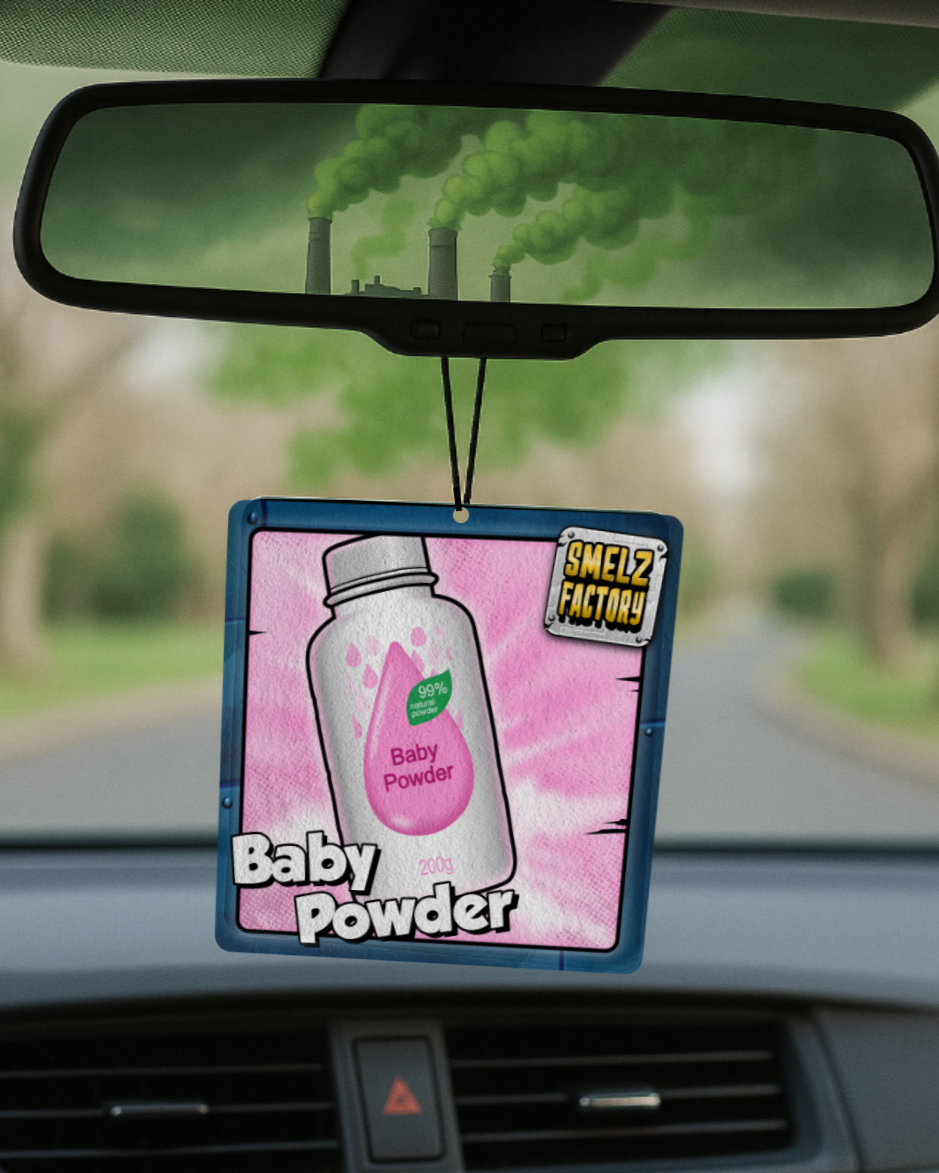 Car air freshener with baby powder scent hanging from a car's rearview mirror.