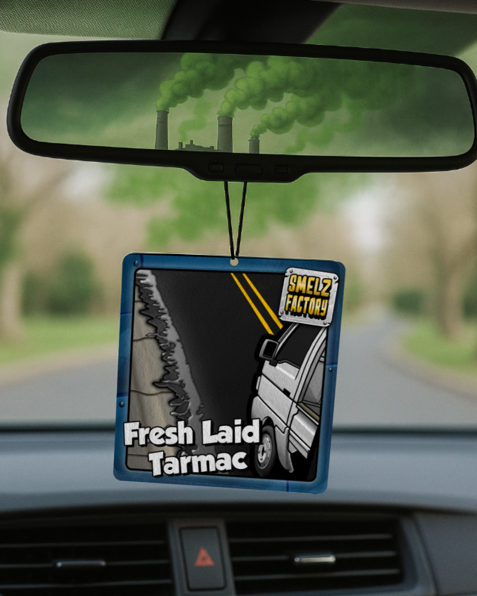 Car air freshener with a graphic design hanging from a car's rearview mirror.
