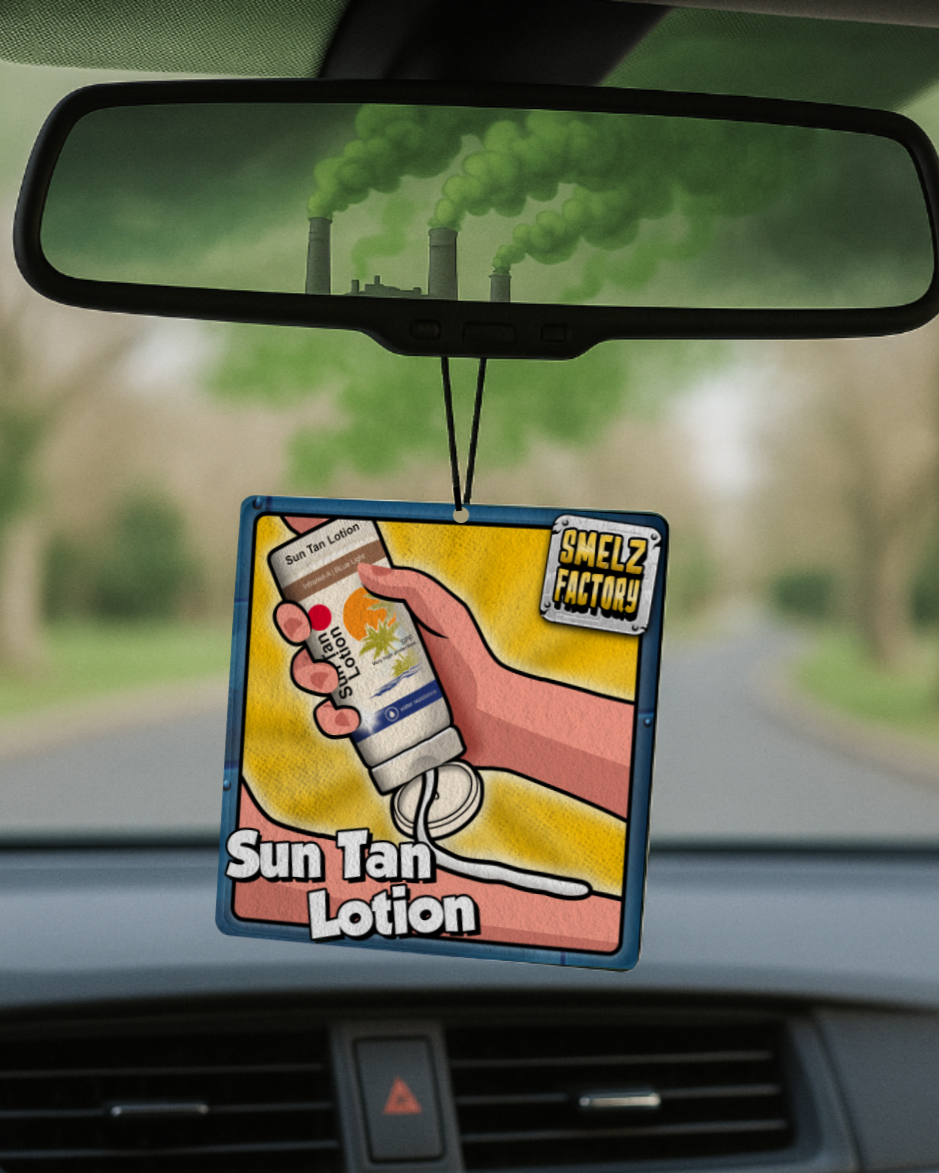 Car air freshener with 'Sun Tan Lotion' design hanging from a car's rearview mirror.