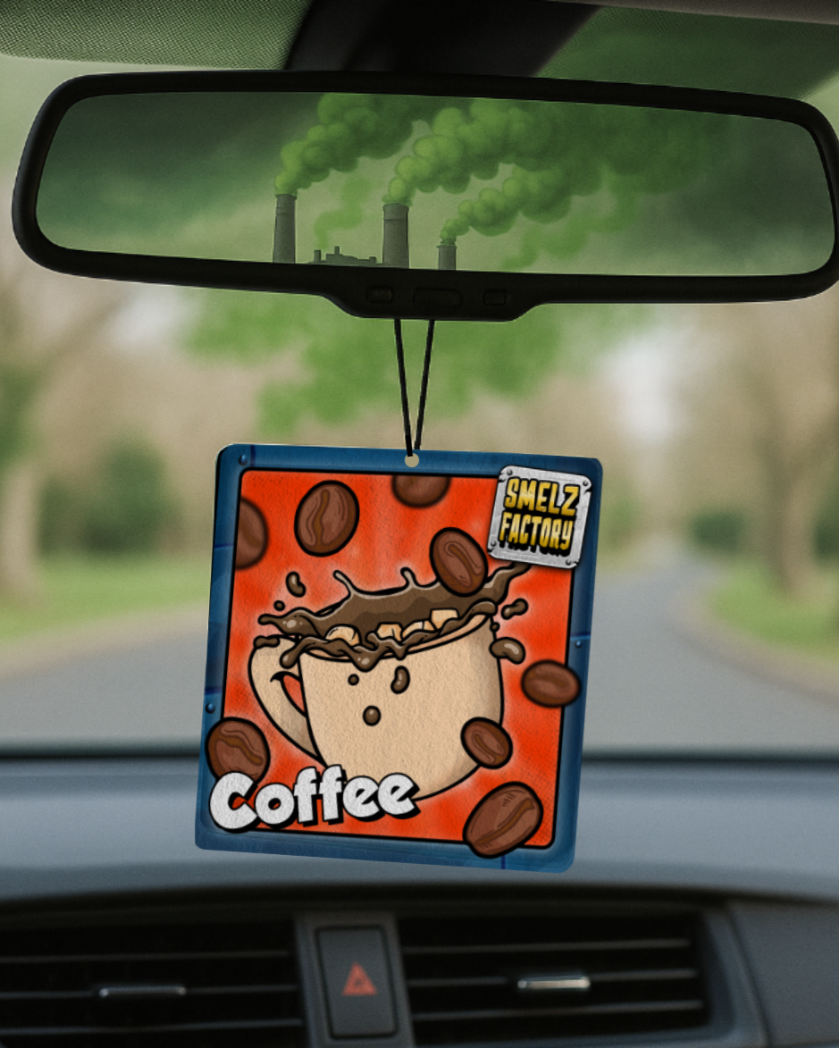 Car air freshener with cartoon coffee design hanging from a car's rearview mirror.