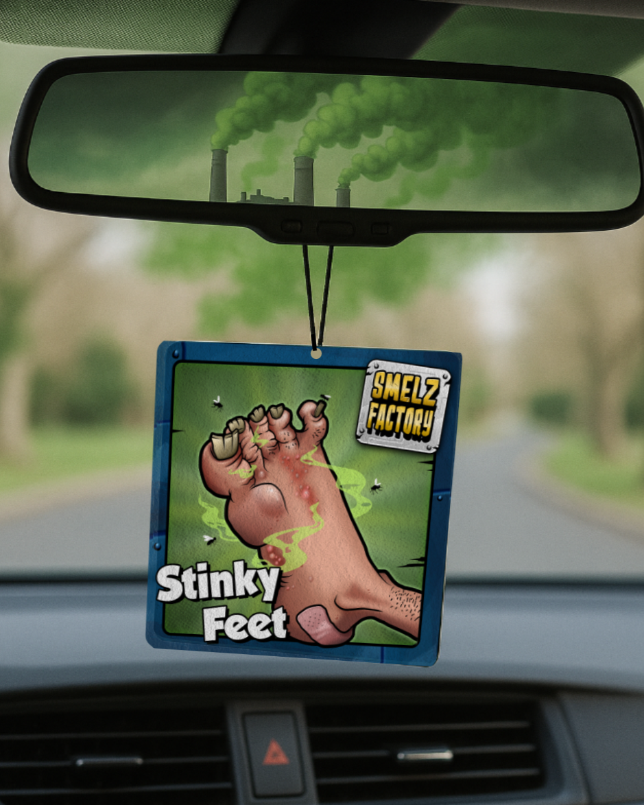 Car air freshener with 'Stinky Feet' design hanging from a car's rearview mirror.